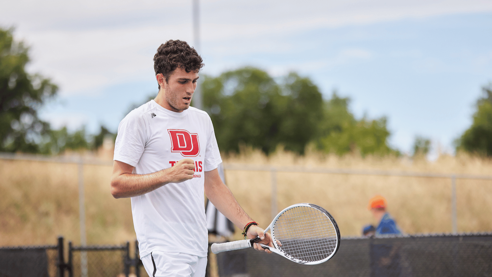 man in white shirt fist pumps