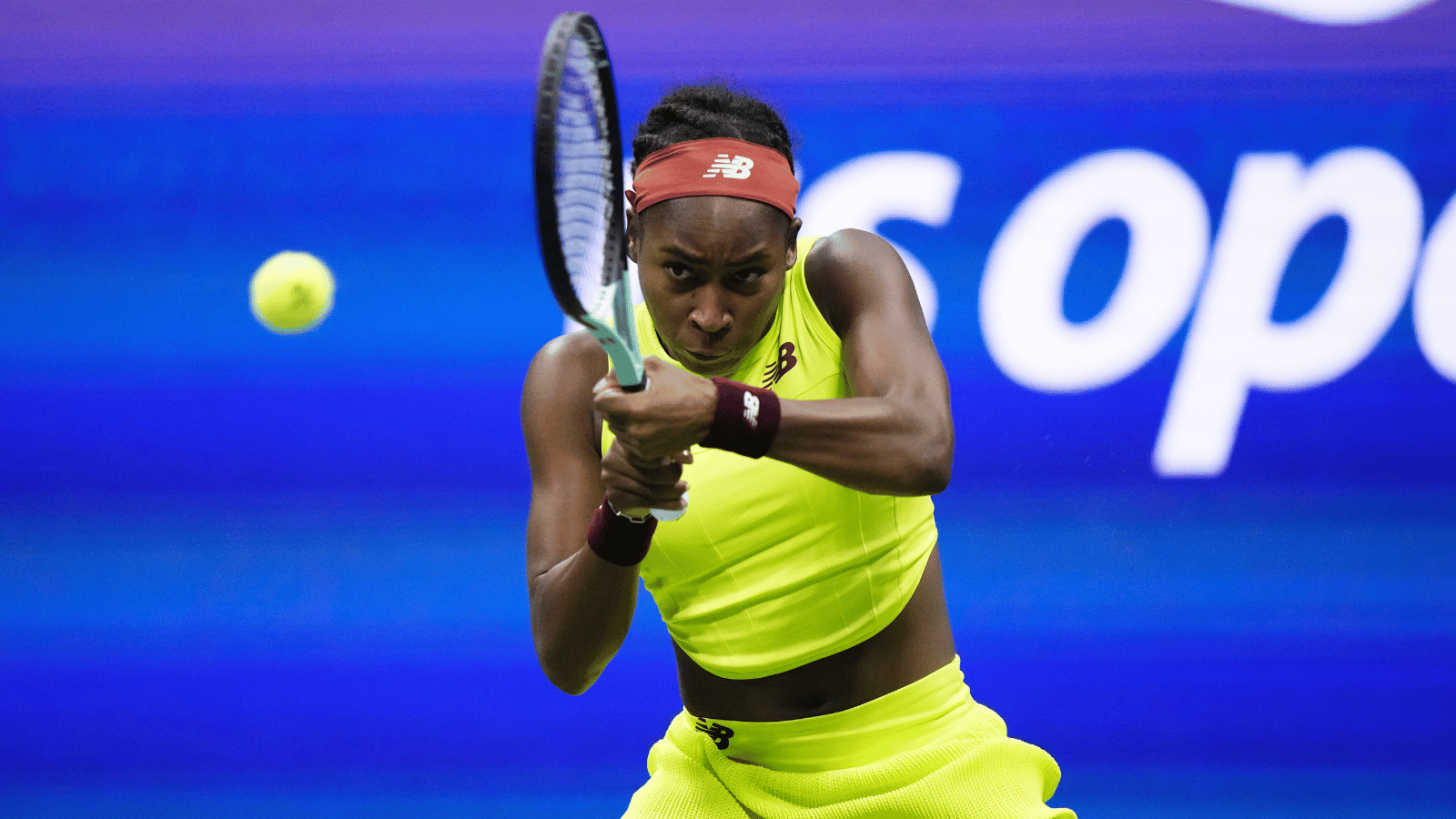 Woman in bright yellow hits backhand