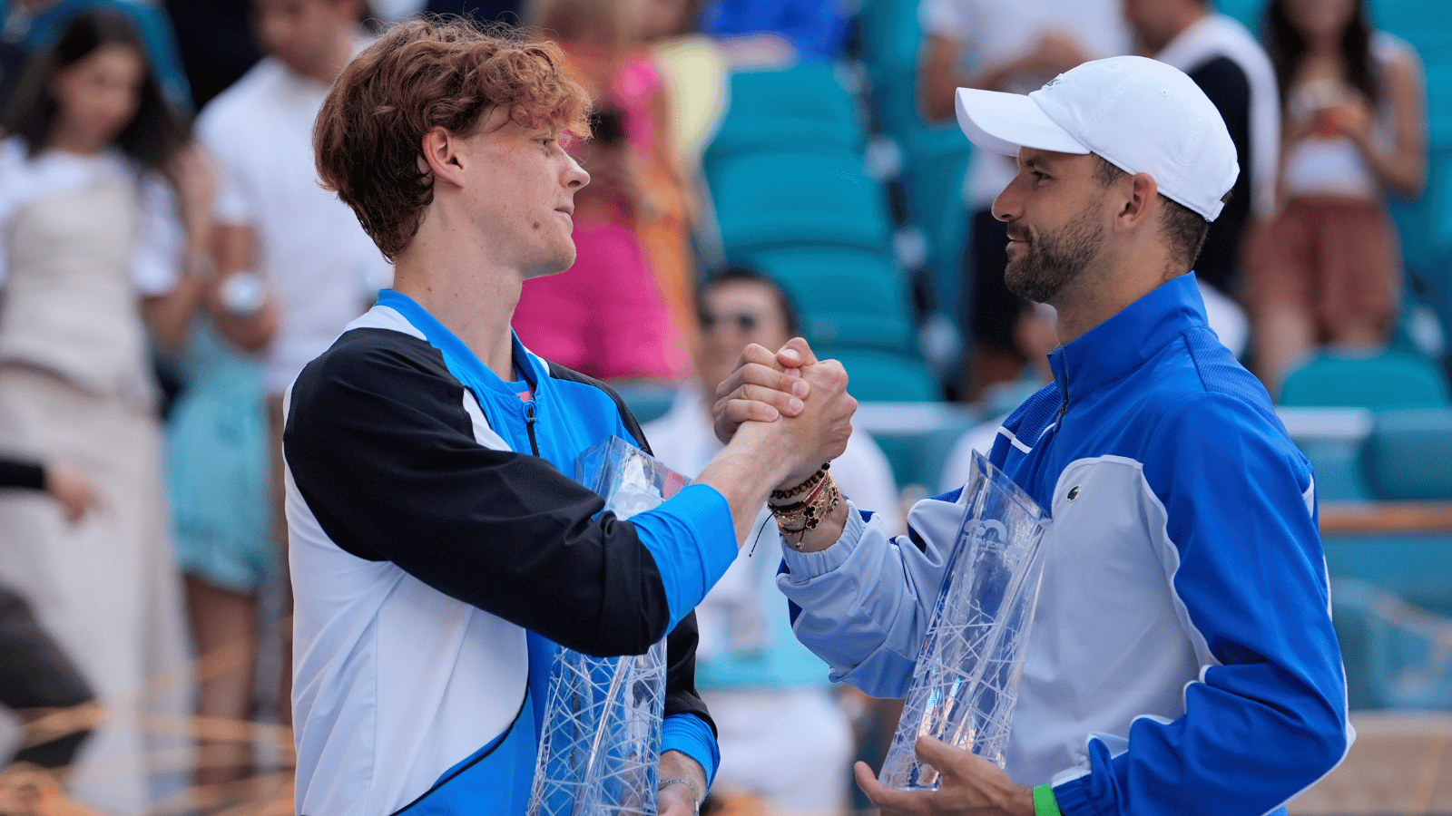 Jannik Sinner and Grigor Dimitrov shake hands.