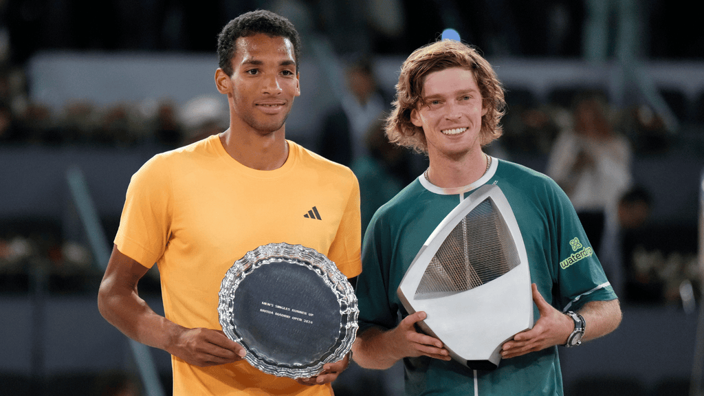 Andrey Rublev and Felix Auger-Aliassime pose with their Madrid trophies.