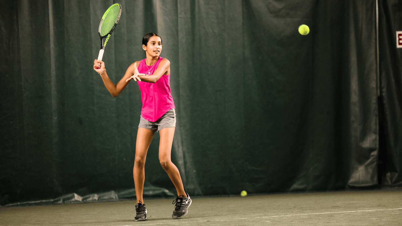 A young girl hits a forehand at SPORTIME in New York.