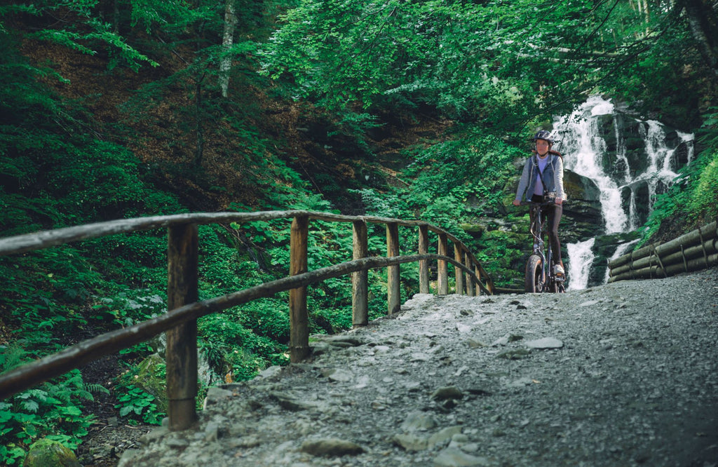 Woman ebiking from waterfall