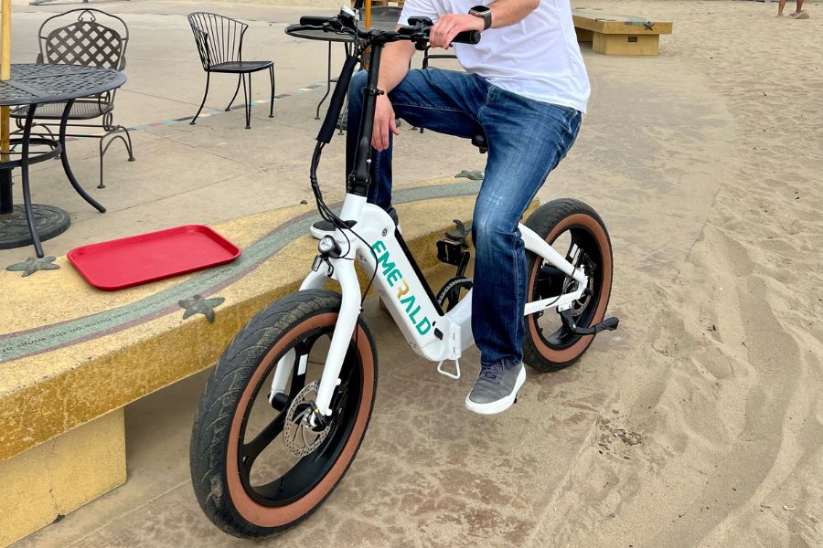 Man sitting on Emerald Ebike at the beach