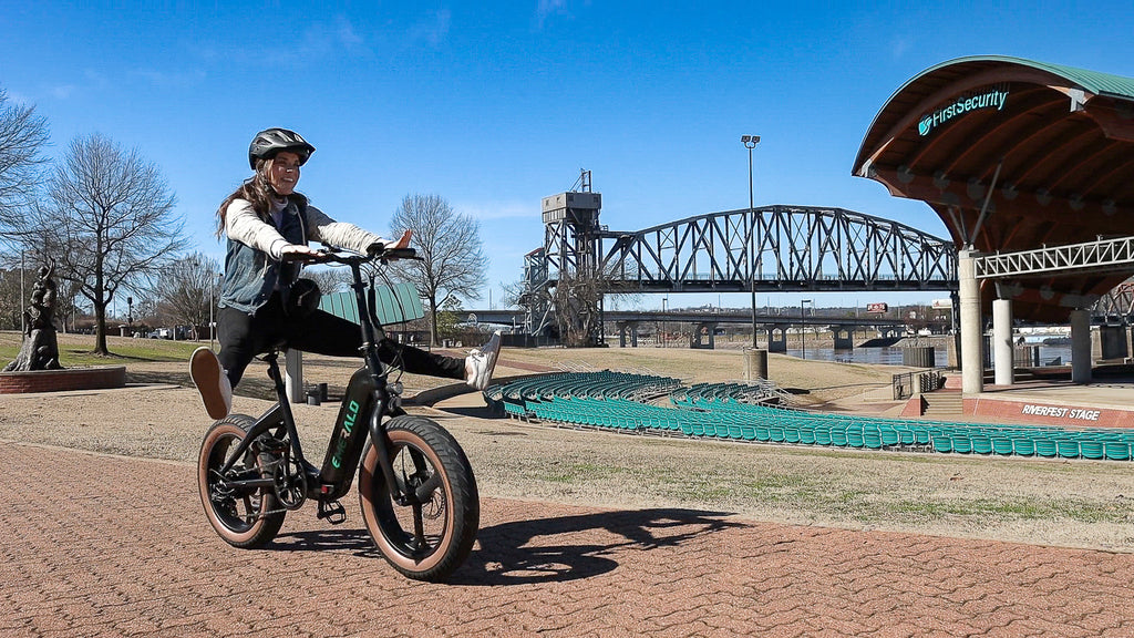 Woman having fun riding the emerald ebike outside