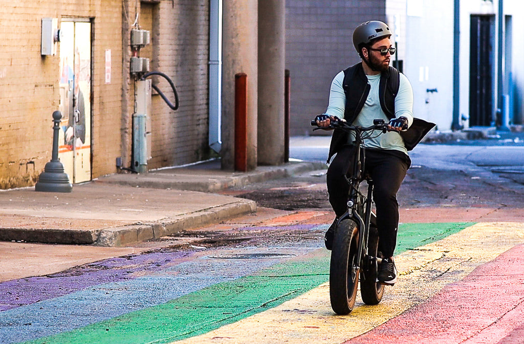 Emerald Ebike being ridden down a rainbow street
