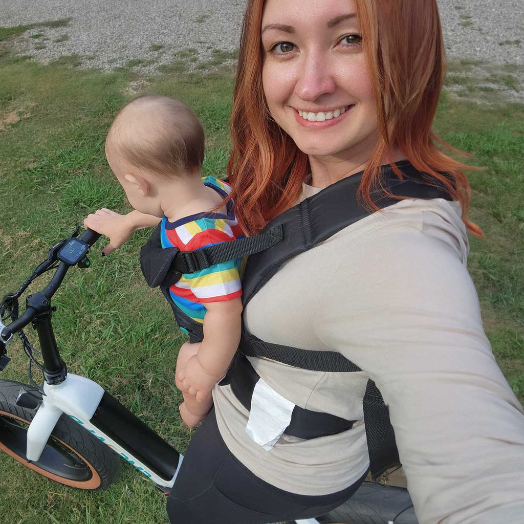 Woman riding Emerald Fold ebike with baby