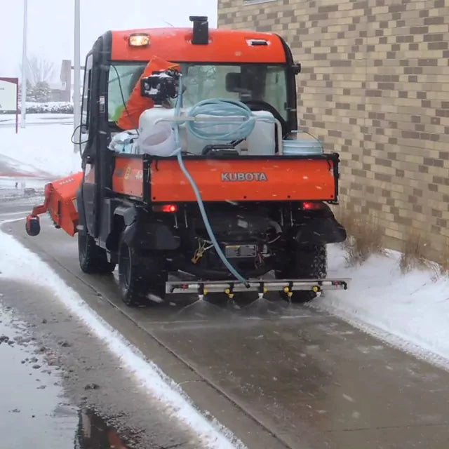 Kubota spraying sidewalk with brine solution