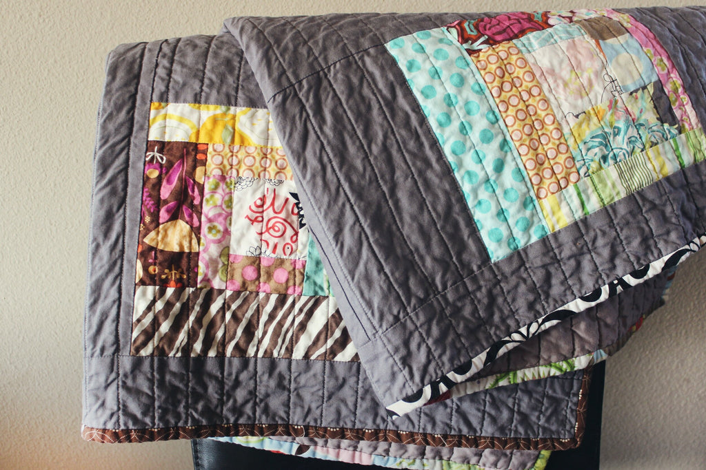 Folded quilts over chair. Image via unsplash.com