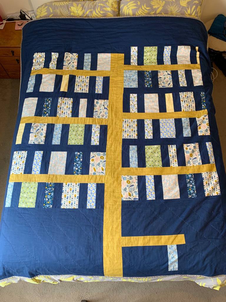 Blue and yellow large scale quilted bedspread by Abigail Beverly