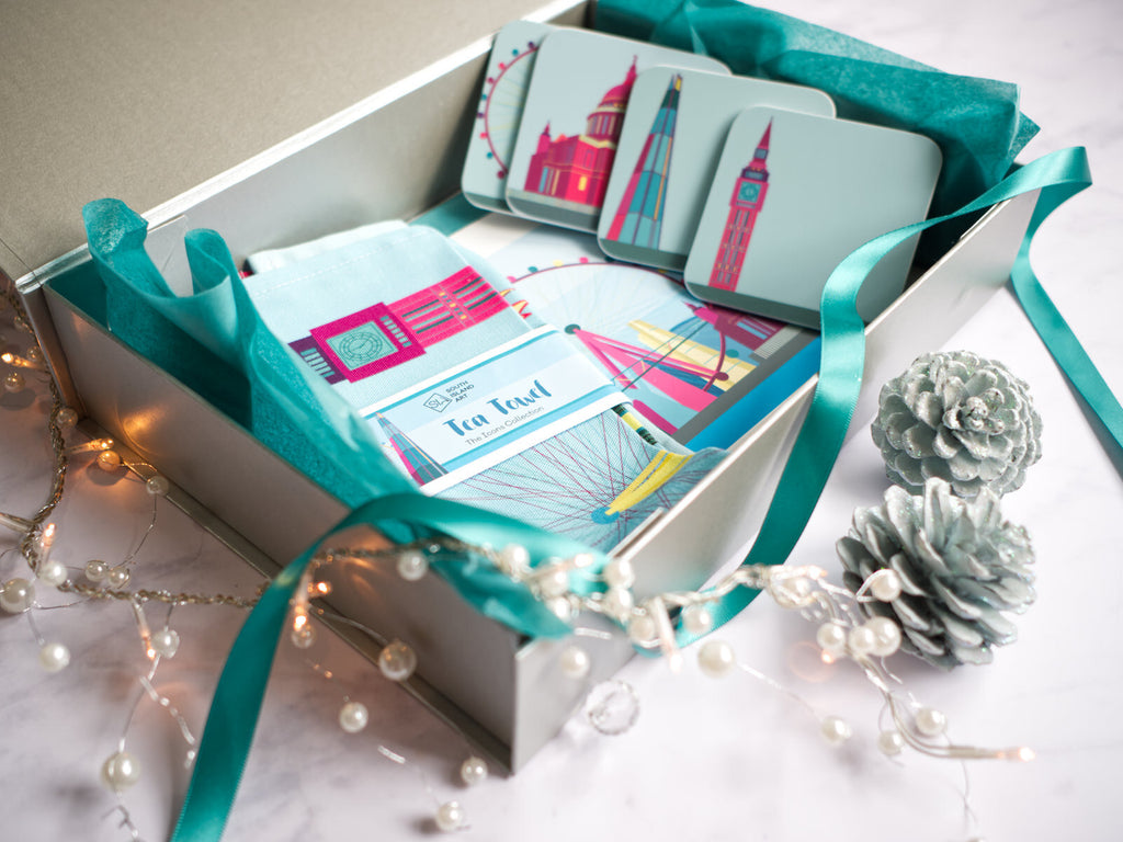 Silver gift box with London tea towel and coasters with ribbon and turquoise wrapping paper