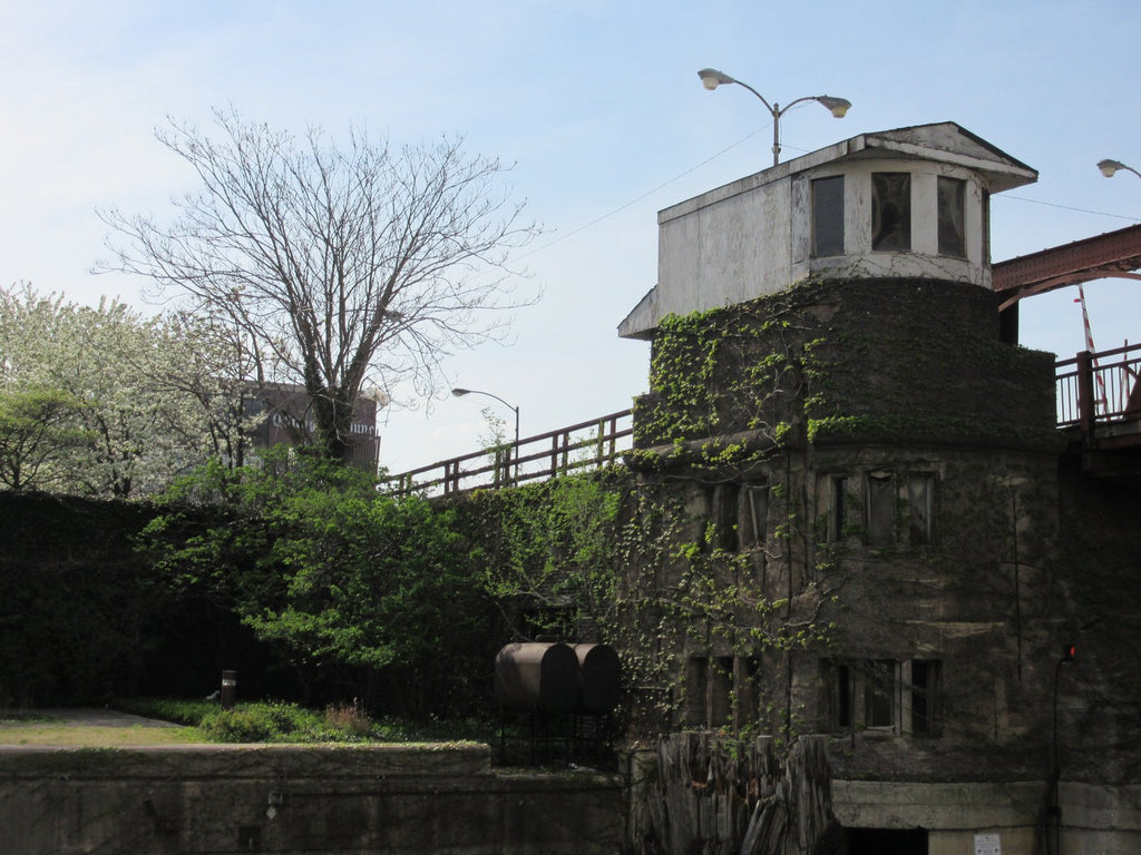 Old Gatehouse with white top covered in moss at a bridge on the Chicago River.