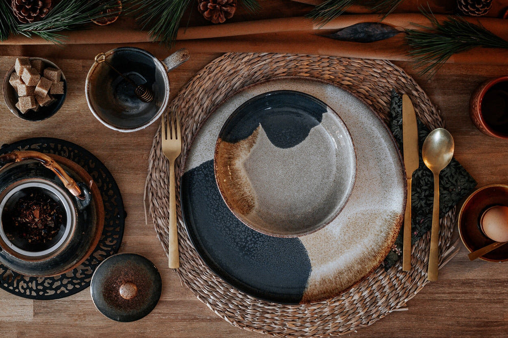 Ceramic plates and cups with abstract circular patterns. Image via unsplash.com