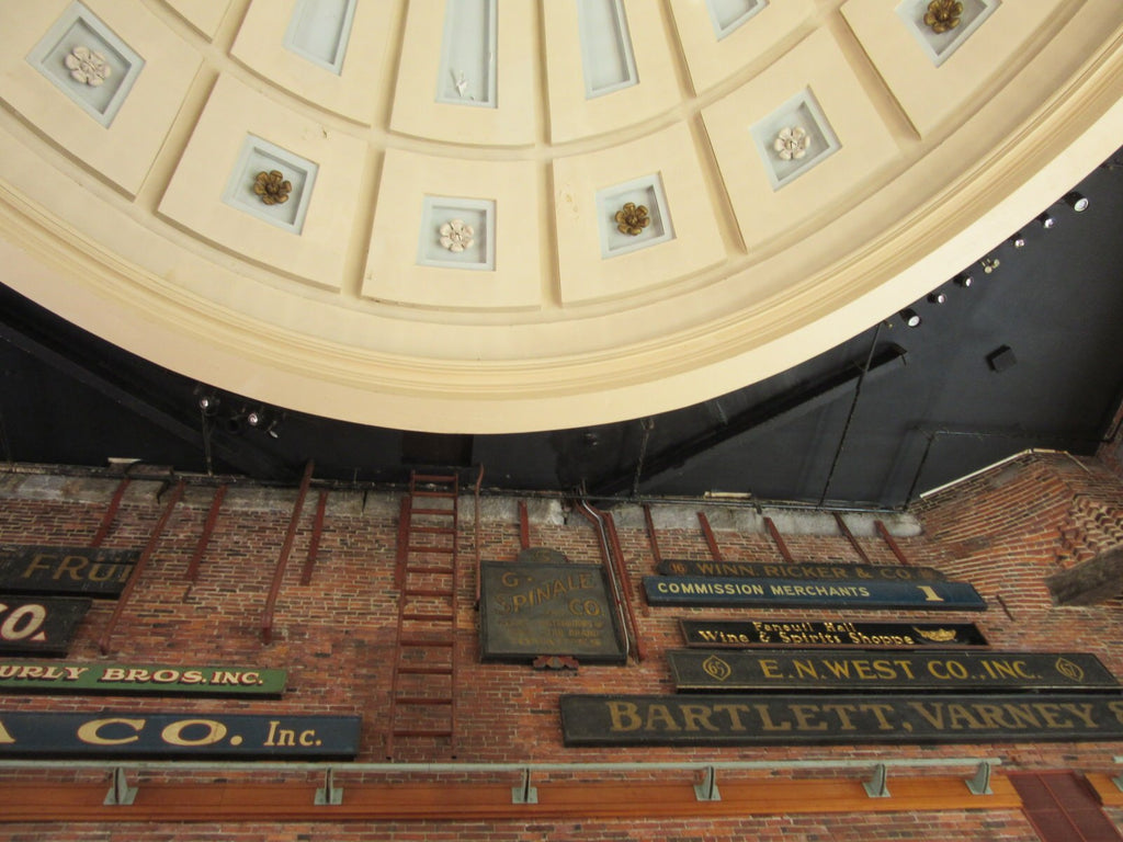 Interior domed ceiling of Quincy Market with old signs.