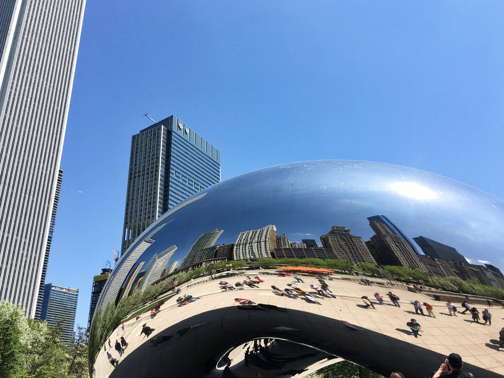 City reflections in the smooth, curve of Anish Kapoor's Bean in Chicago.