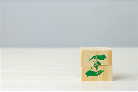 Four blocks stacked together, forming a symbol of green hands, representing eco-friendly benefits of using silicone products.