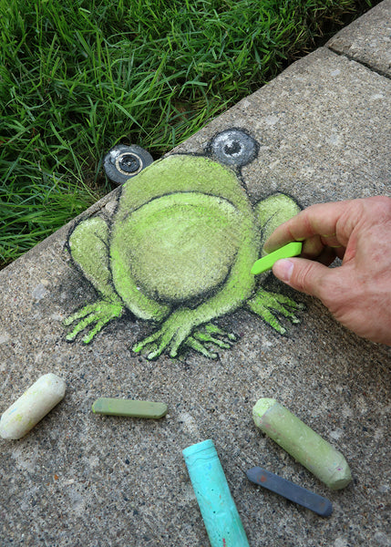 chalk drawing of frog in progress, using sprinler head as one of the frog's eyes