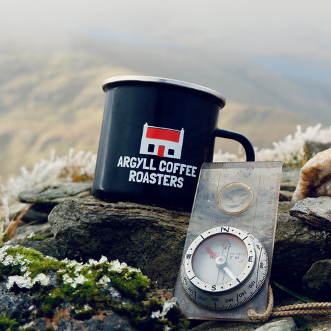 Coffee mug and compass coffee adventure subscription