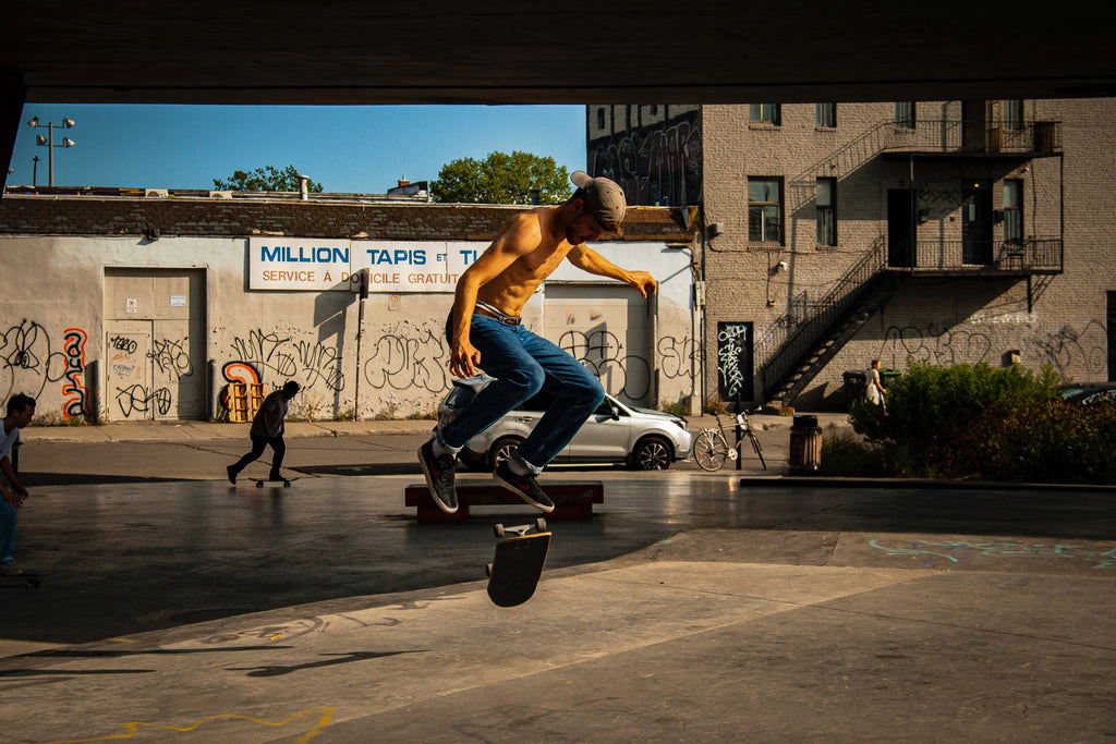 A guy skateboarding under an overpass in Montreal