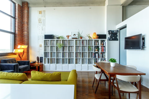 A sparse living room with a large bookshelf