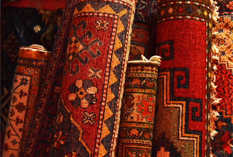 A collection of Armenian rugs displayed for sale