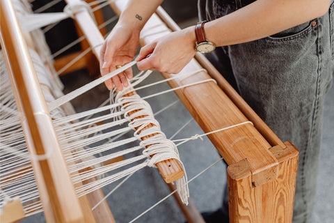 A Woman Using a Loom