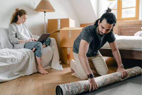 Woman with Laptop and Ethnic Boyfriend Laying Carpet