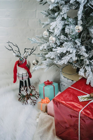 Wrapped presents and holiday décor over a plush white faux fur rug