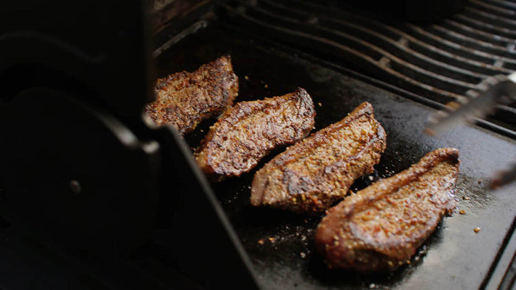 Image of For the steaks, put the garlic oil on the griddle,...