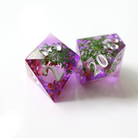 Arcane apothecary liquid core resin dice set with herbs on white background