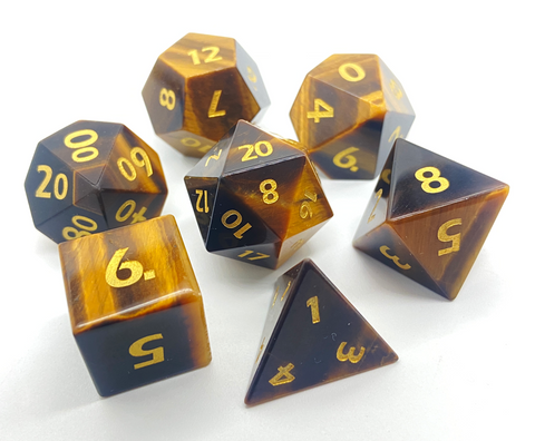 Yellow Tiger's Eye gemstone dice set on a white background