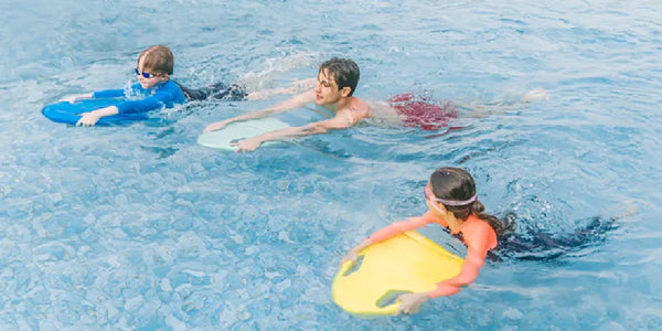 Two kids and adult using Asiwo Mako electric kickboard scooters in pool.