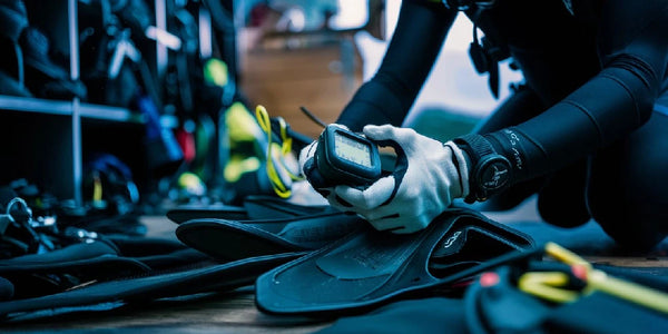 Close up of scuba diver selecting gear from dive locker.