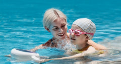 Adult and child using Sublue Hagul EZ underwater scooter in pool.
