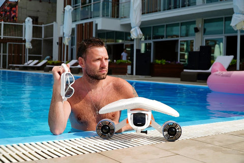 WhiteShark Mix Sublue Underwater Scooter next to pool with a man.