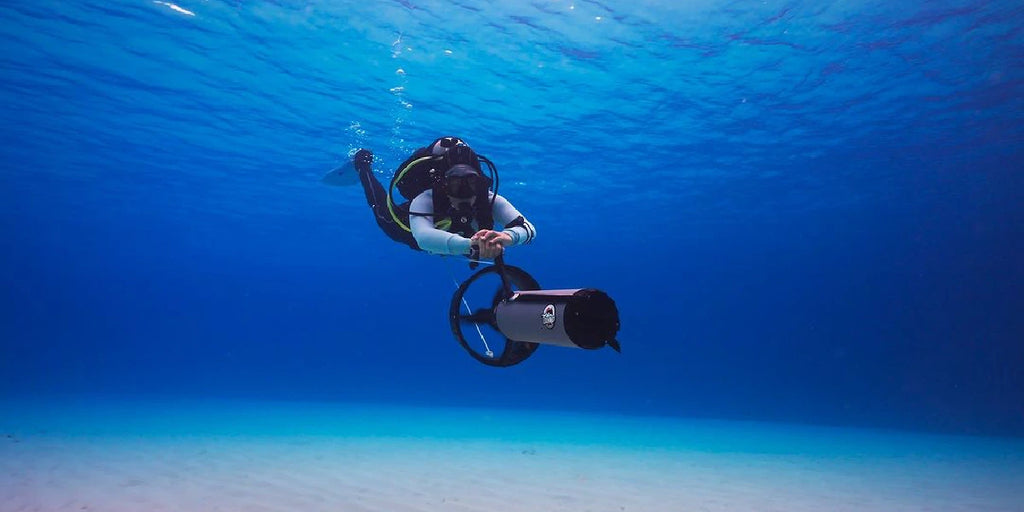 Diver using Dive Xtras BlackTip underwater scooter.