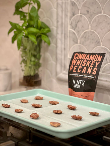 Cinnamon pecans placed on a baking sheet to toast for a cinnamon pecan infused Old Fashioned.