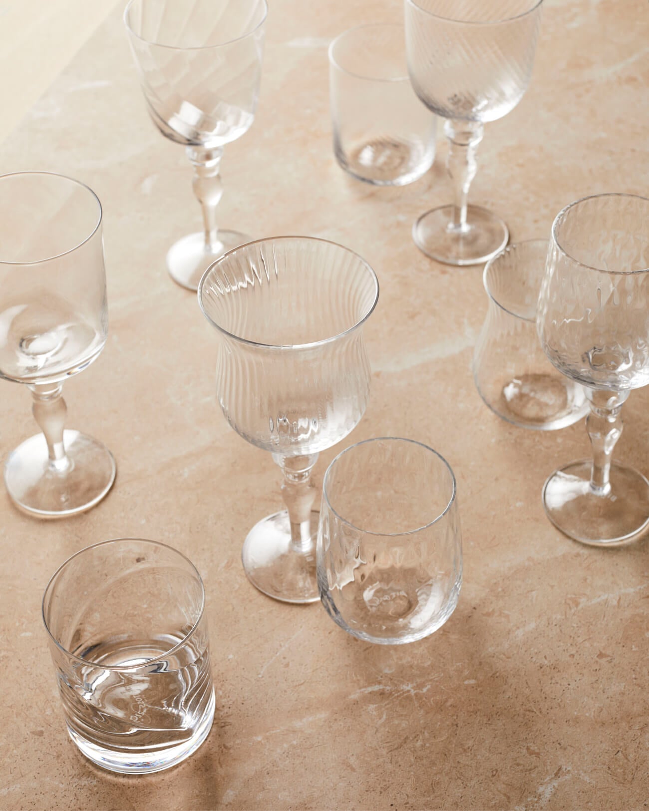 Selection of mis matched vintage glassware, tumblers, wine glasses from The Social Kitchen mix and match design trend