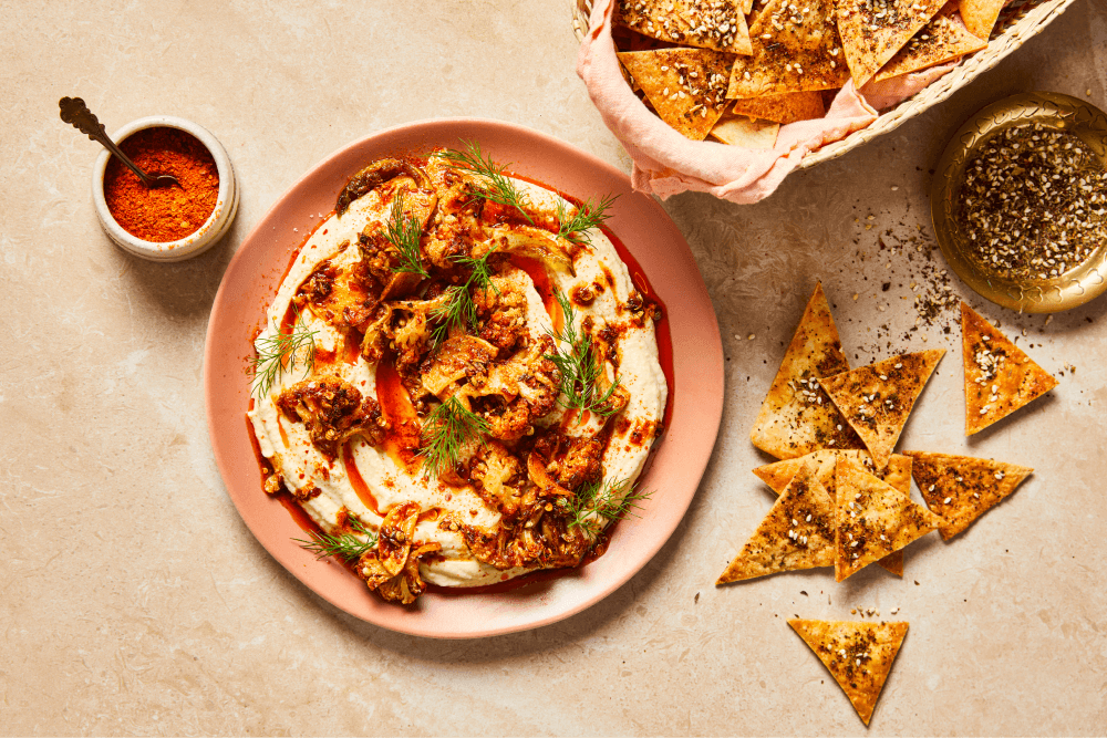 Roasted Spiced Cauliflower Topped Hummus served with nacho chips