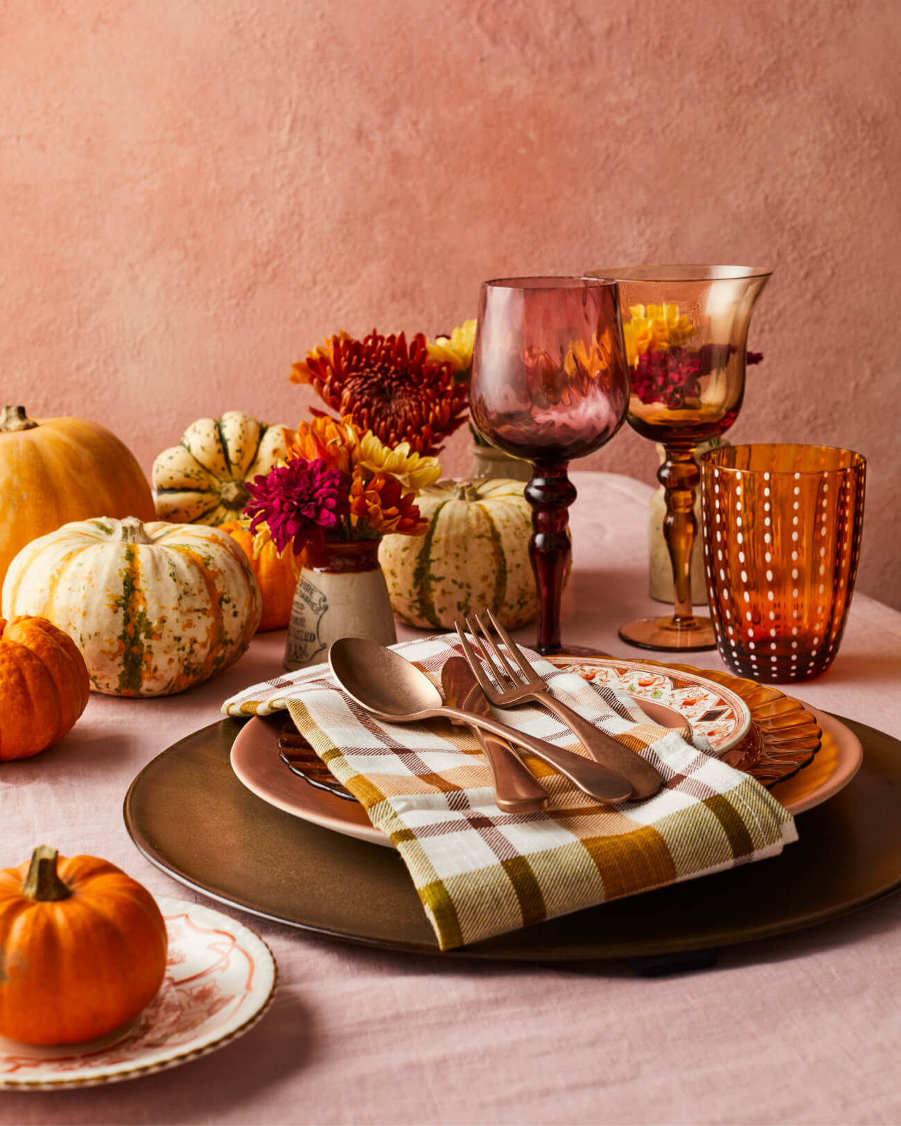 Thanksgiving place settings with mixed vintage and modern crockery and glassware with in pinks, browns, oranges and reds from The Social Kitchen