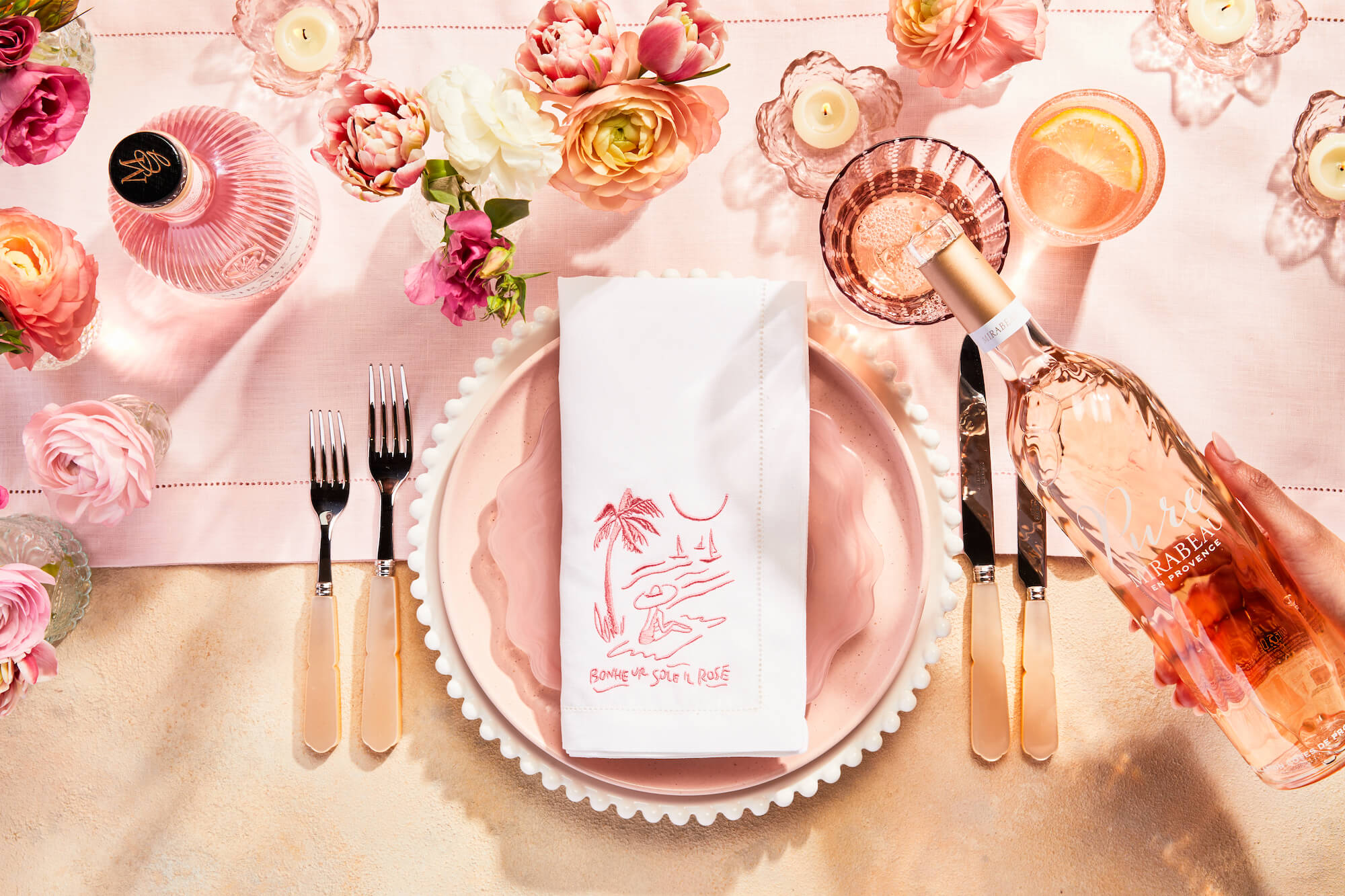 Bottle of Mirabeau rosé being poured into a glass on the Summer Dining Rosé Edit tablescape