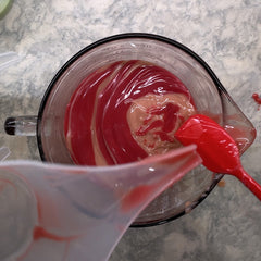 Pouring pink soaps back into the large container (the moment I knew I needed to change my design plans)