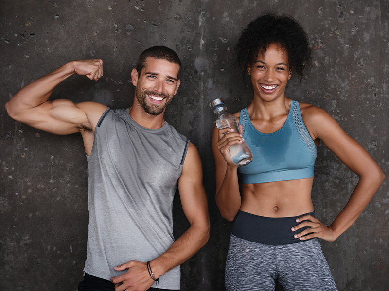 Man and women sweating in the gym