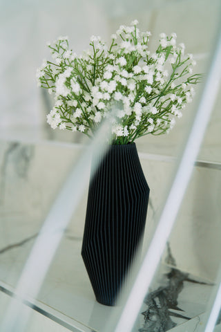 A black vase with a modernist vase design by Woodland Pulse - an online seller of modern vases and more.