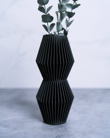A black vase with a modernist vase design by Woodland Pulse - an online seller of modern planters, unique flower pots, black vases and more.