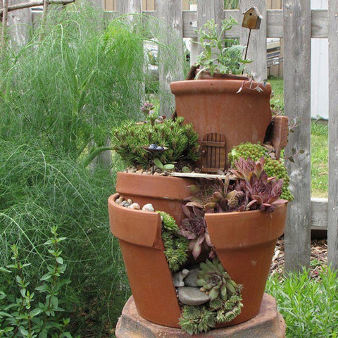 Tiered garden pots using broken terracotta flower pots.