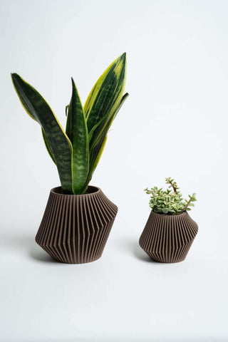 Two brown boho DISC planters by Woodland Pulse.