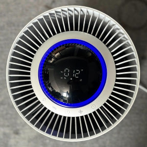 Top view of a circular air purifier with a digital display in the center.