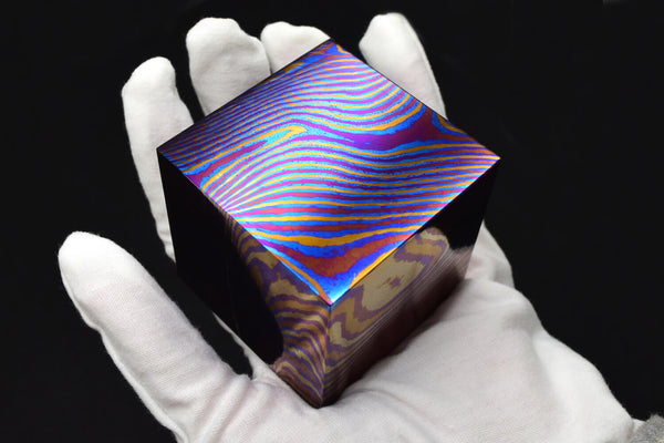 holding a Timascus cube of 1 kilogram