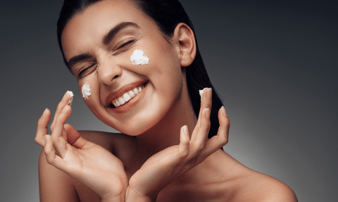 Woman Applying Cream on Face