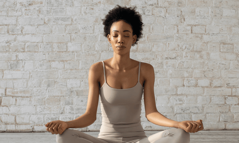 Woman Meditating to Reduce Stress